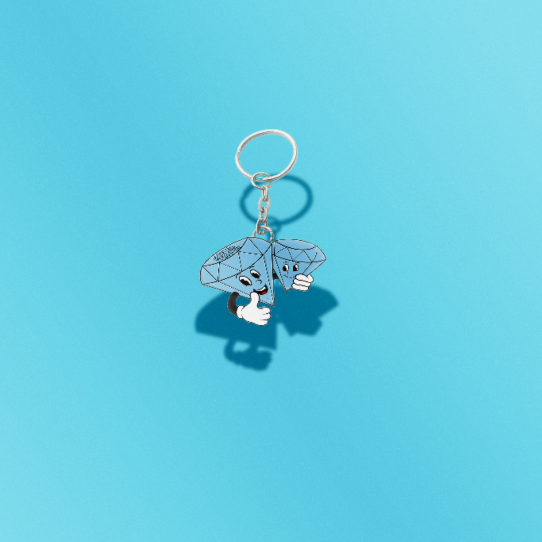 Keychain with cartoon character holding diamonds on a blue background